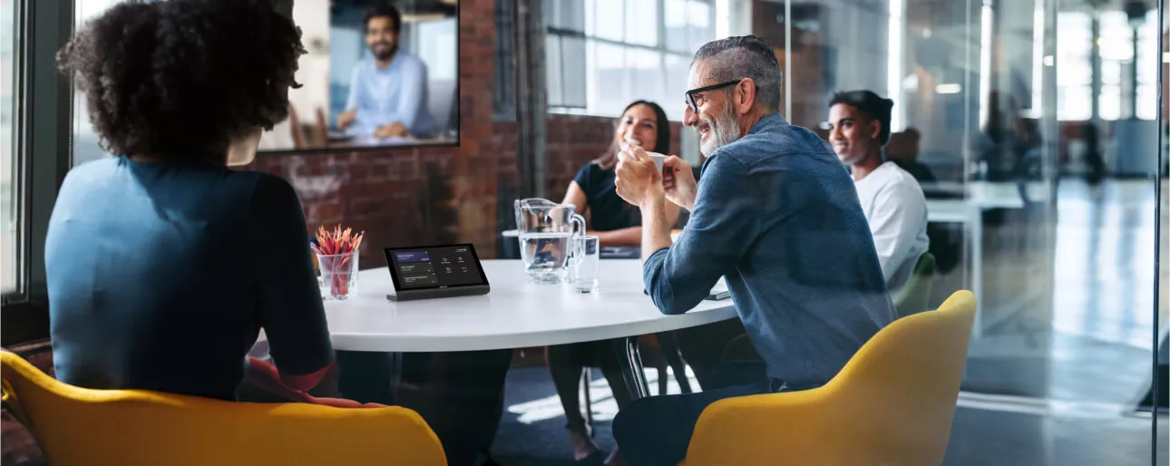 Huddle room meeting around a tabletop touch panel